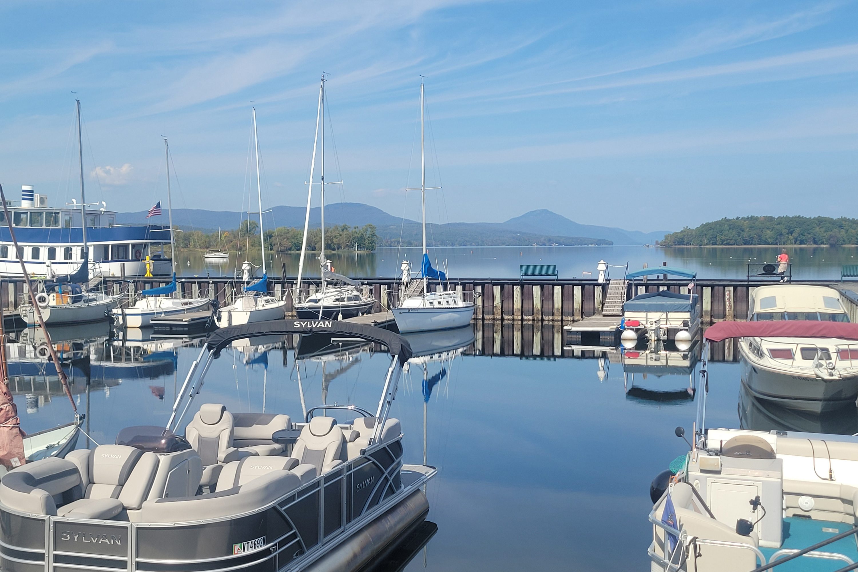 A photo of a lake with boats docked on it.