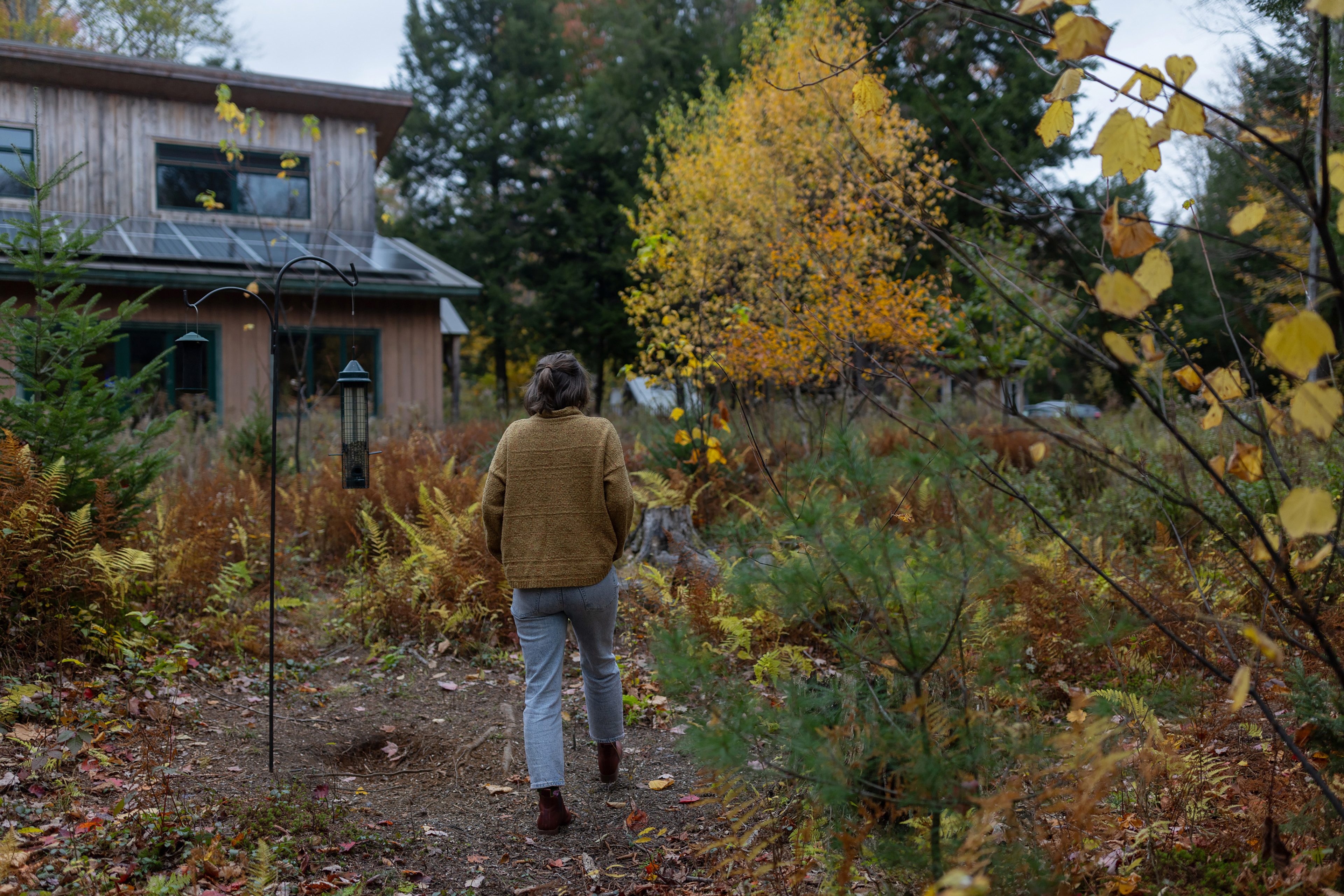 A photo of Leah Kovitch walking to her home from her meadow.